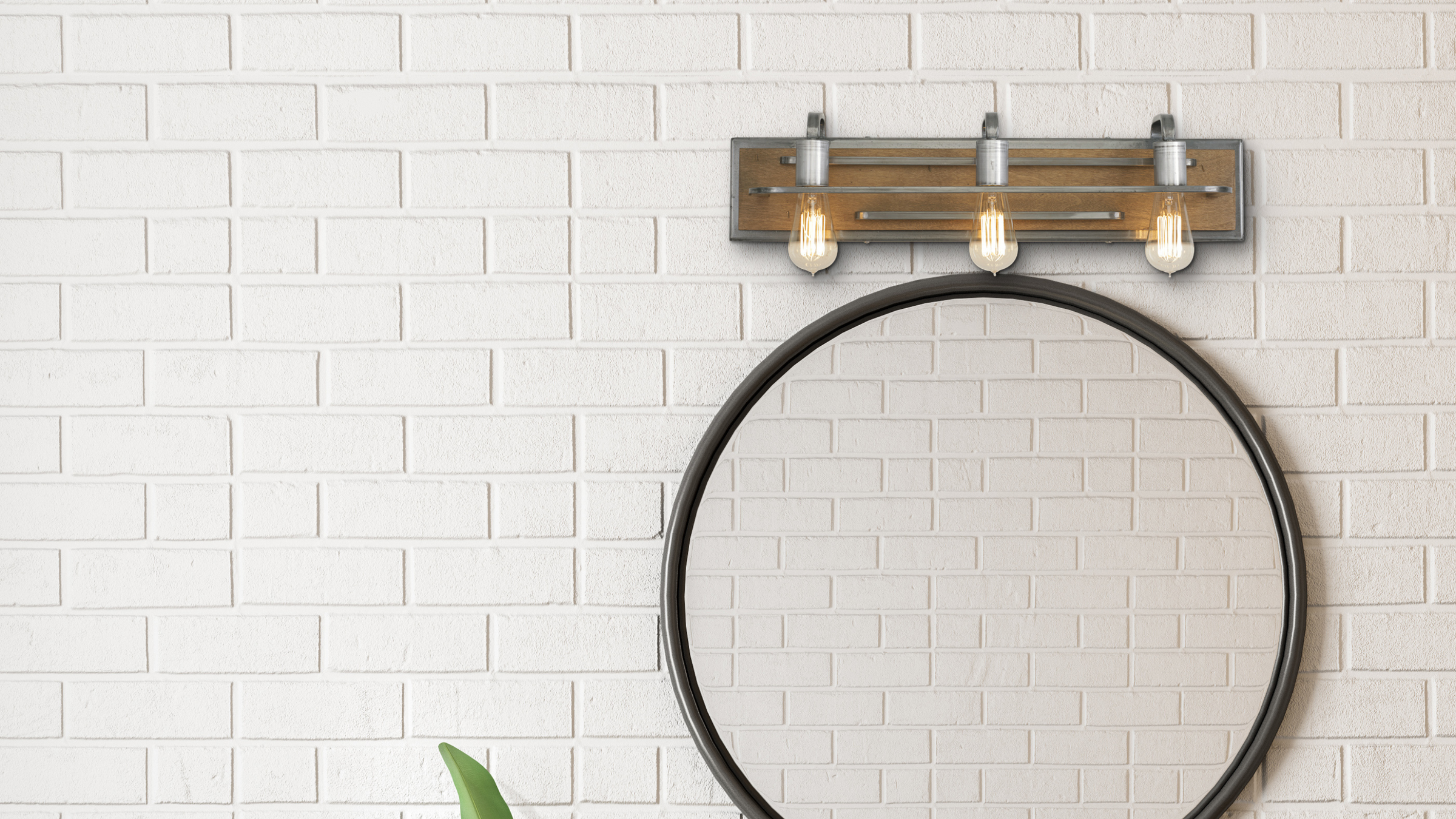 Lofty steel and wood bath fixture shown hung over mirror on a white brick wall